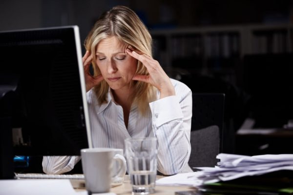 Stressed businesswoman working late